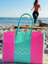 Woven beach tote bag in bright colors. 100% handwoven, made in small batches from recycled plastic. 