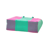 Woven beach tote bag in bright colors. 100% handwoven, made in small batches from recycled plastic.